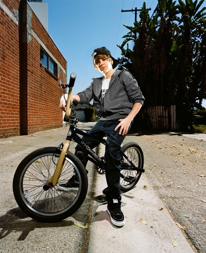 Justin Bieber posing on a bike